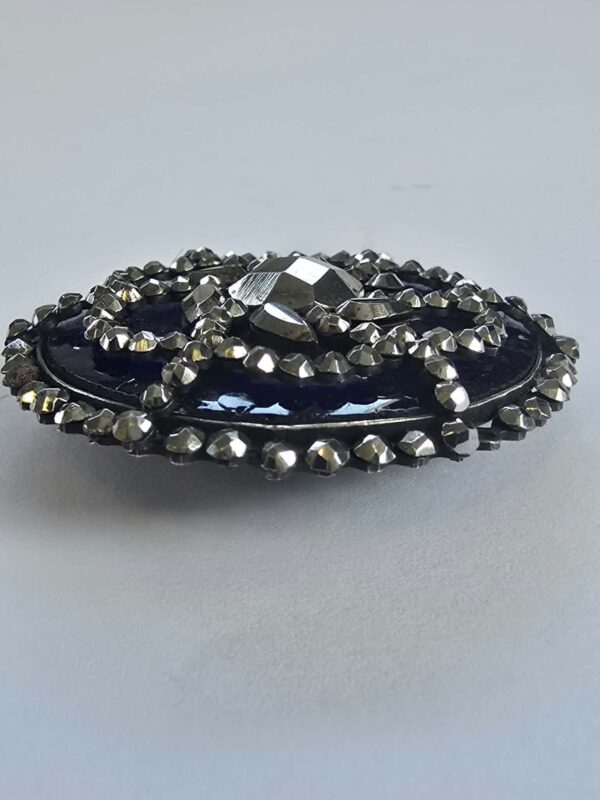 8407aabf-7de2-4b63-91e9-286cb72ebc26 Cut Steel Over Blue Glass Button