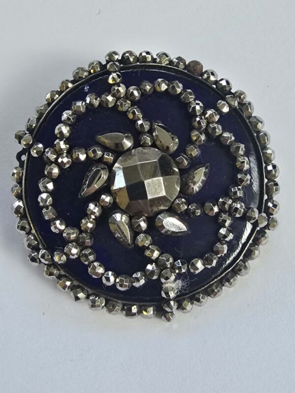 96168230-24f5-465e-8e2f-d34b87793f6b Cut Steel Over Blue Glass Button