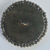 e58d1770-2972-4a1c-9b3a-1a8e1e34c3fb Cut Steel Over Blue Glass Button